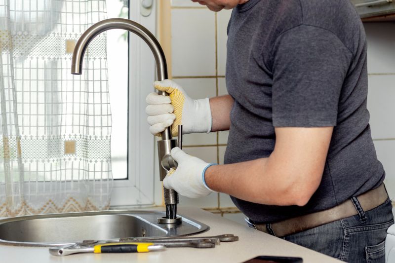 Handyman Repairing a Leaking Faucet